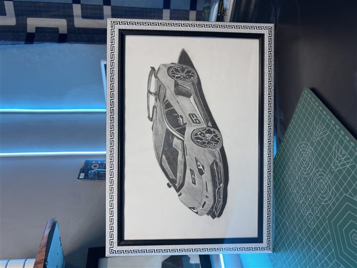 Framed graphite sketch of a sports car